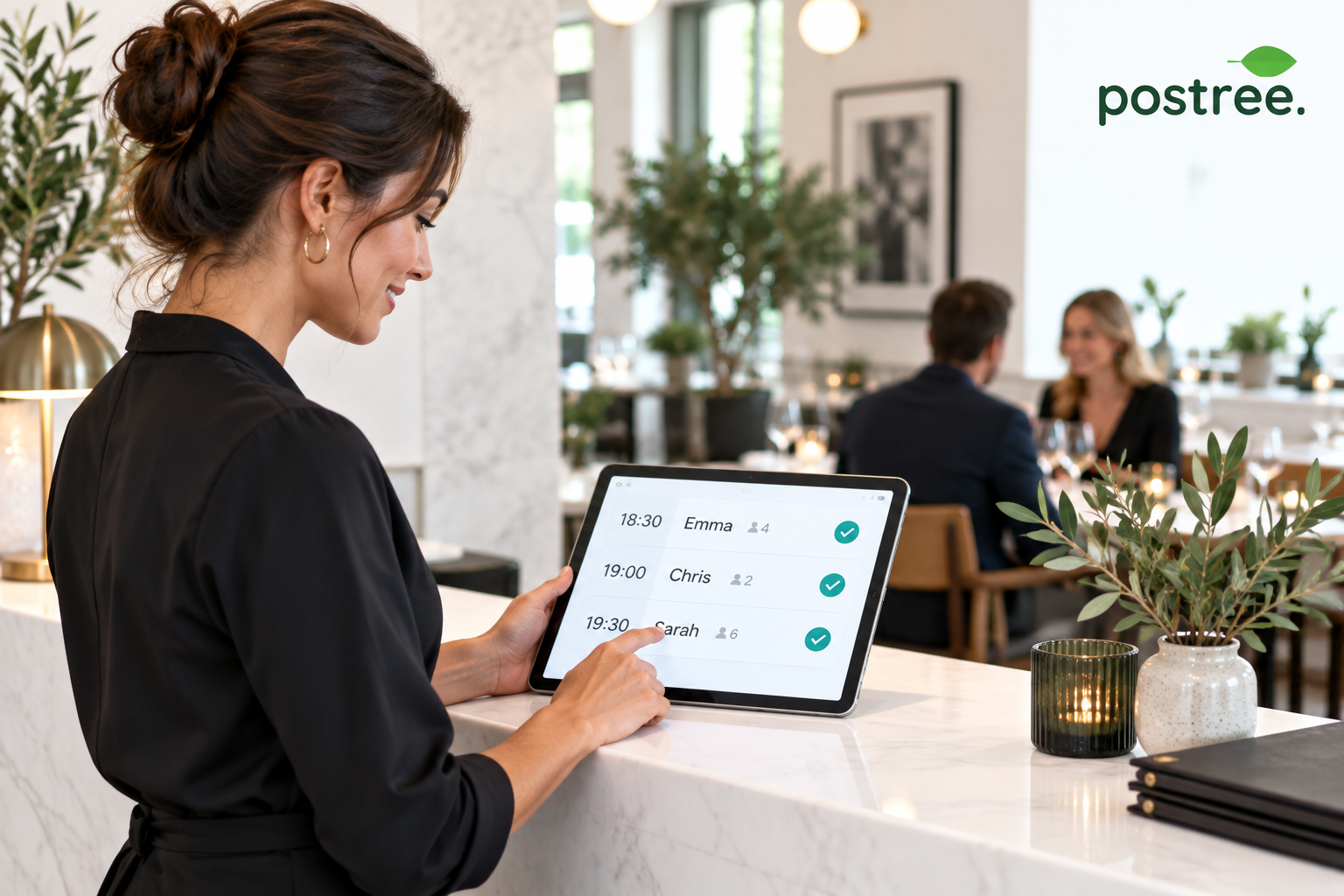 Restaurant host checking a clear bookings list on a tablet.